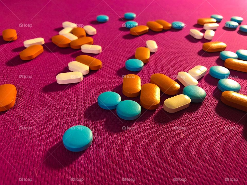 Pills on a pink background.