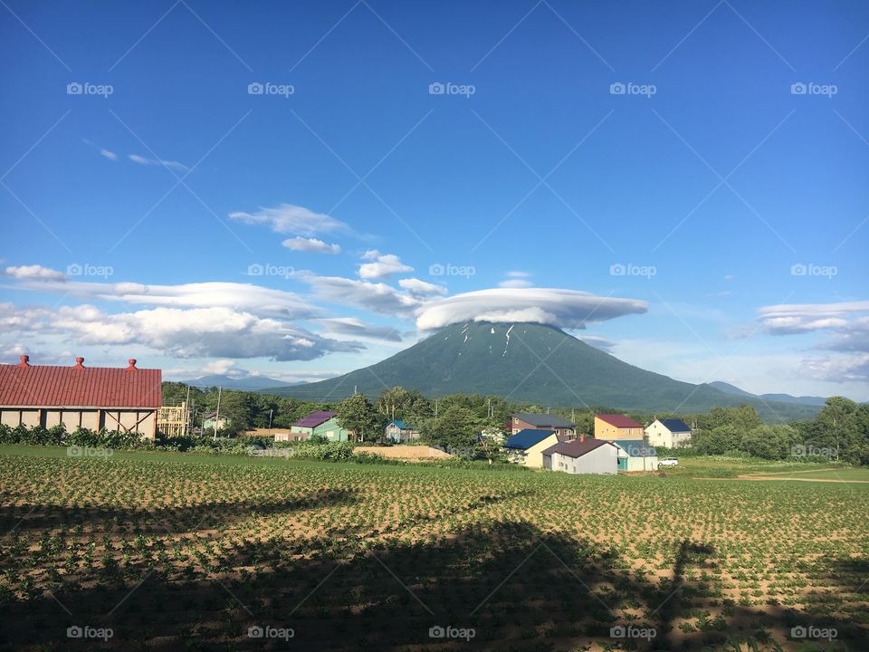 Mount Yotei on a clear sunny day. Taken while going for a jog around the farm land