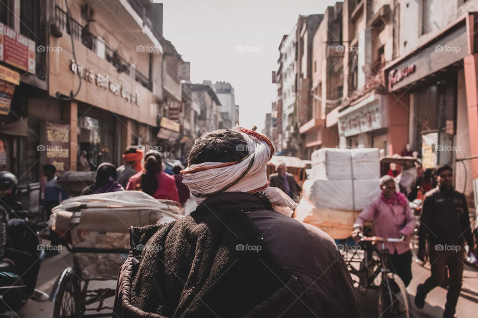 Bustling City Street In India.
A man walks through a busy street as the hustle and bustle of city life moves around him.