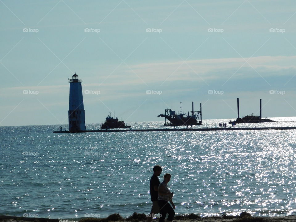ships approaching lighthouse