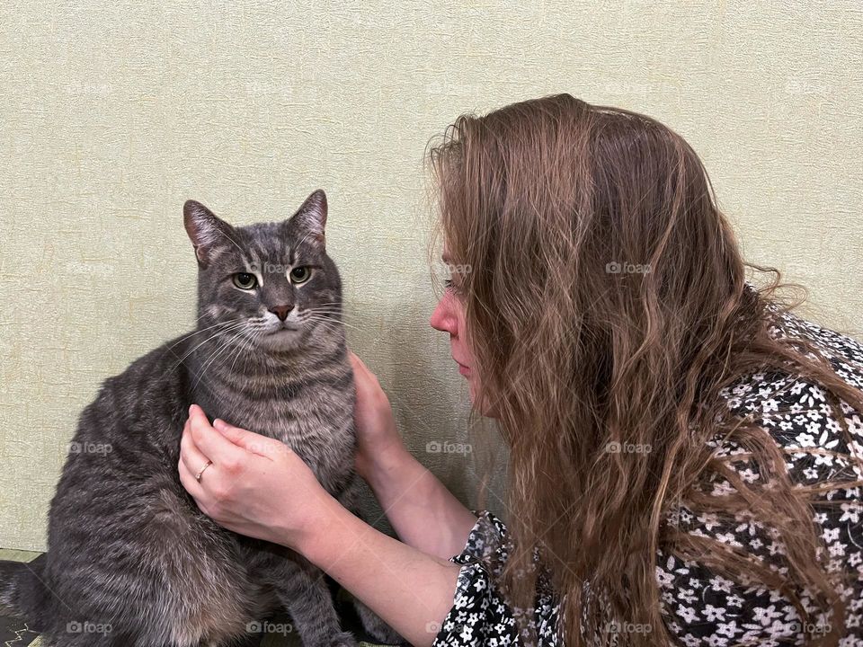 Cat and woman are hugging 