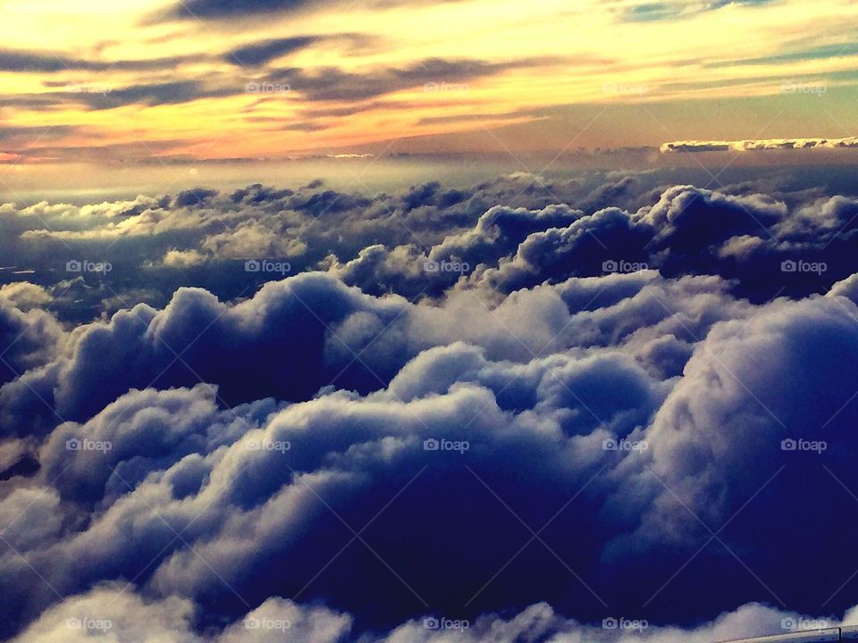 Heavenly. Sunset on a flight above a heavenly blanket of clouds