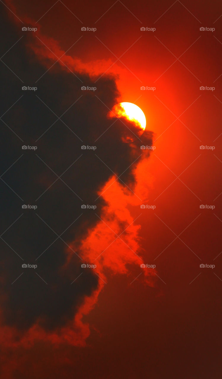 The Sun Behind a Cloud on a Smokey Day due to Fires