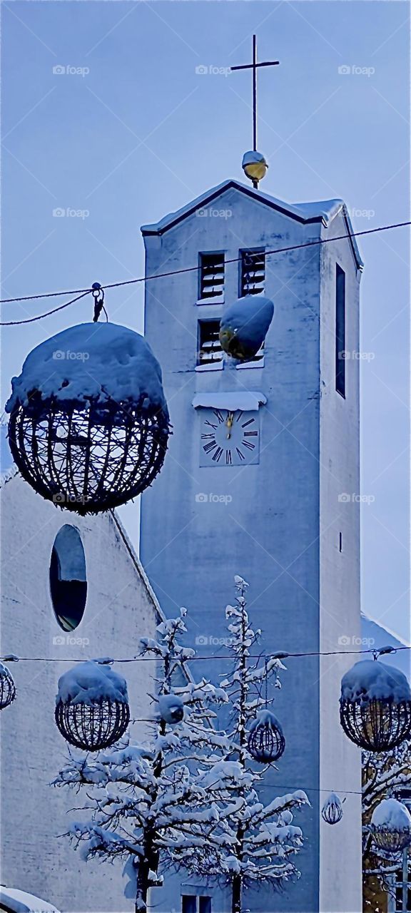 The „Christuskirche“ in „Straubing“, „Bavaria“, Germany is a work of art to behold. At Christmas time large cast iron decorations are strung up on a cable now covered in snow, remnant of the blizzard of early December 2023. Hypnotic Productions