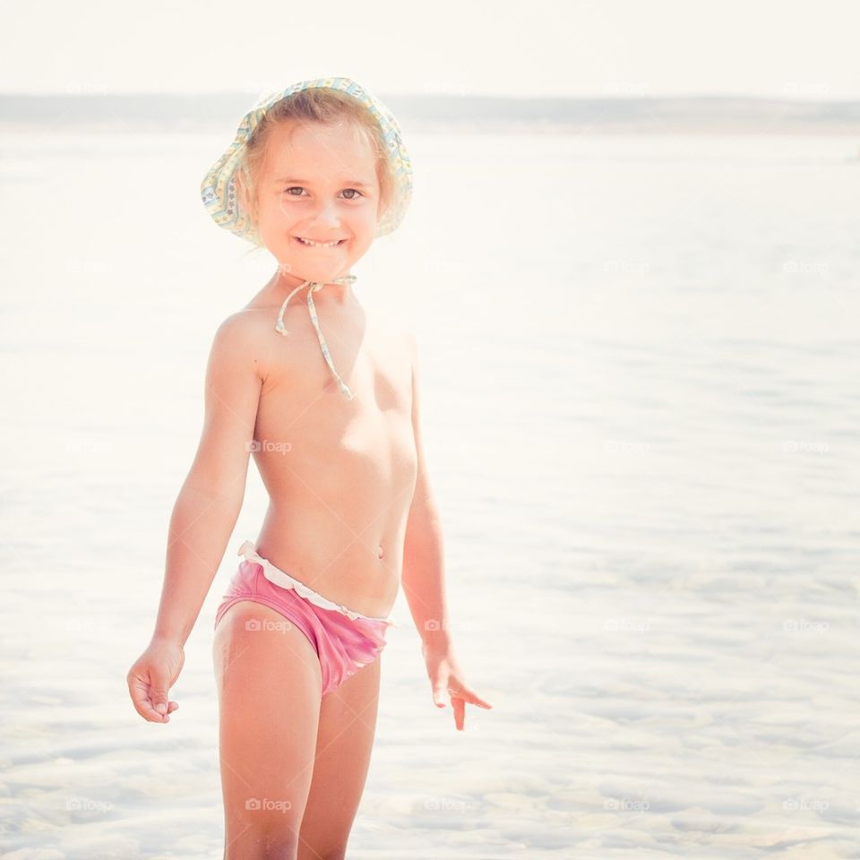 Little girl standing in the sea