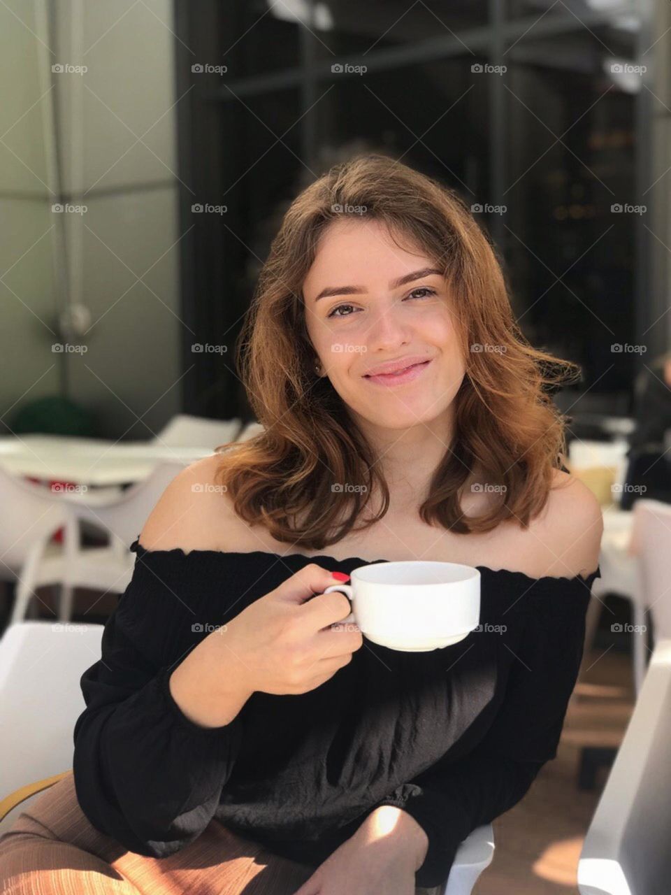 Girl drink coffee in summer city 