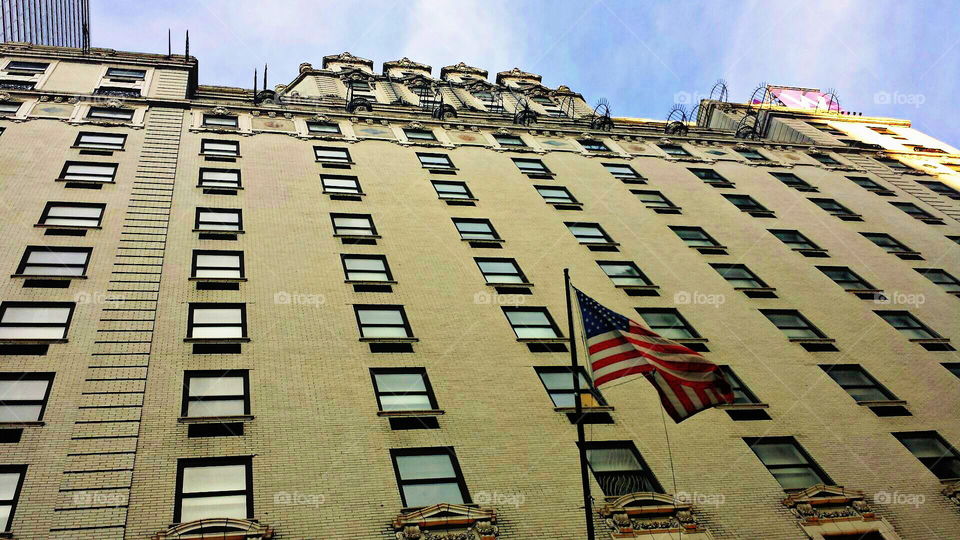 NYC skyline. USA flag on side of building