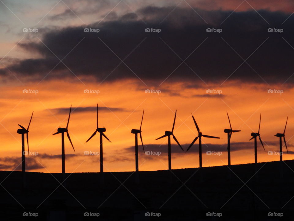 Sunset time with lots of mixture colours with wind turbines 