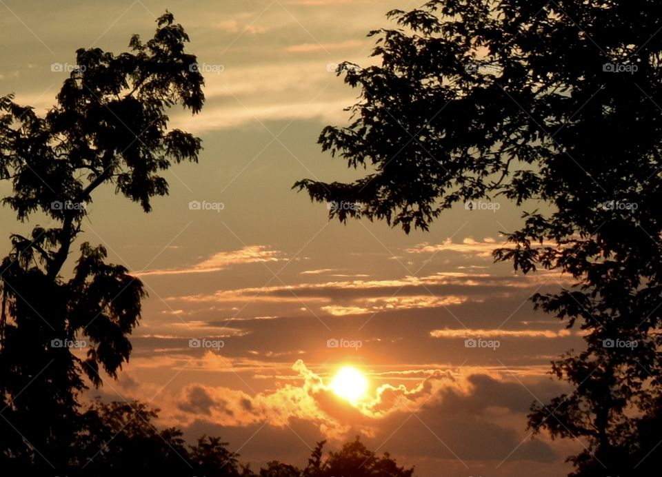 Evening sun setting behind the clouds