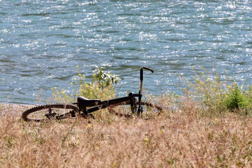 Child’s bicycle abandoned beside river 