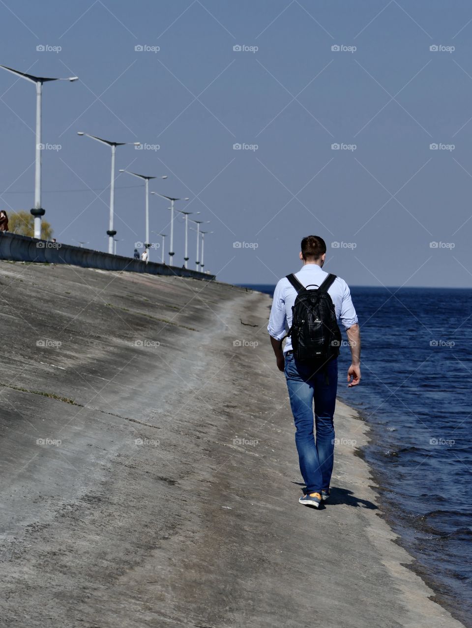 Man walks on the sea coast in kiev