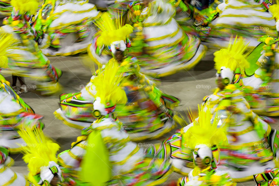 Lots of people during carnival, motion blur, yellow color