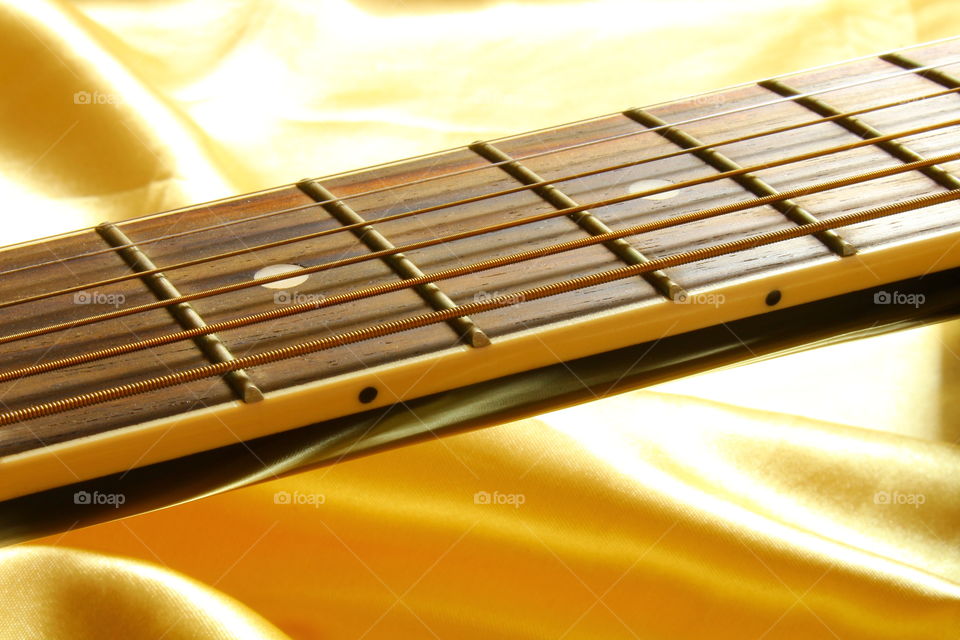 acoustic guitar on Golden textile