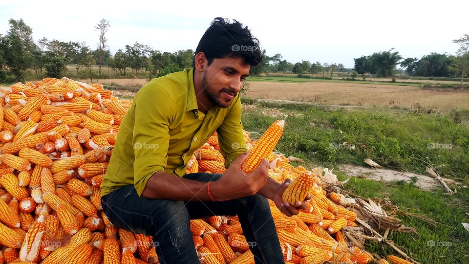 happy farmer with maize