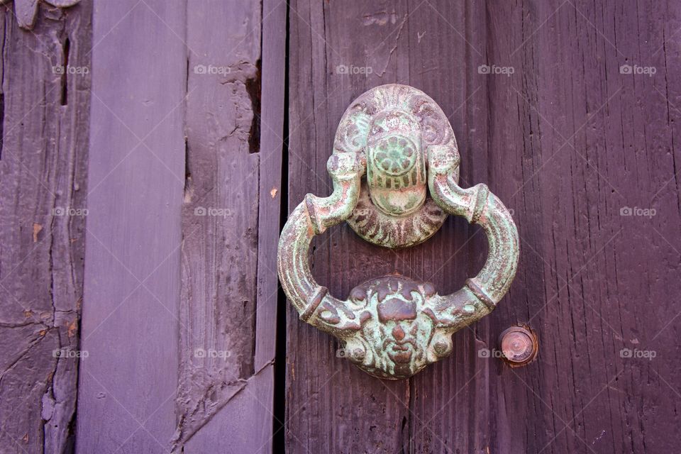 Old doorknob on wooden door