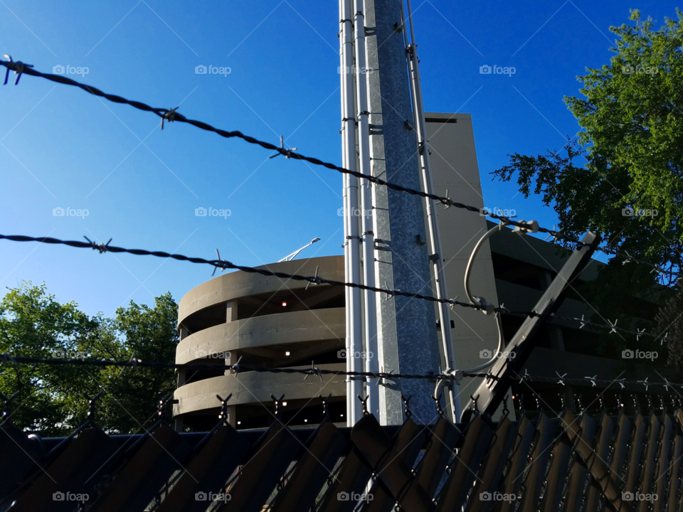Power caged with a backdrop of a concrete behemoth