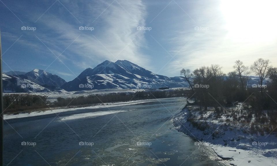Gentle river flowing through the snow covered mountains.