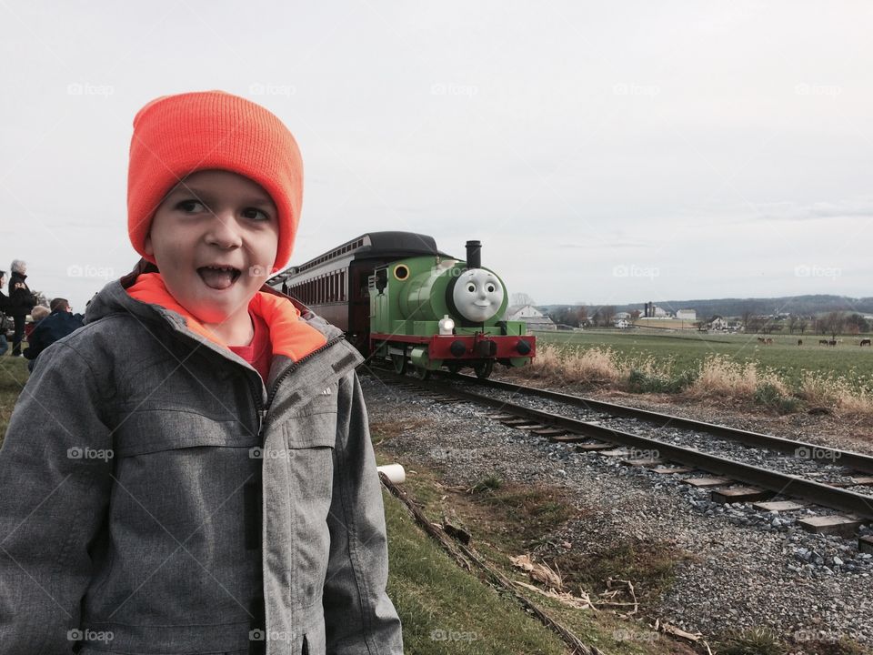 Portrait of cute child standing near railway track