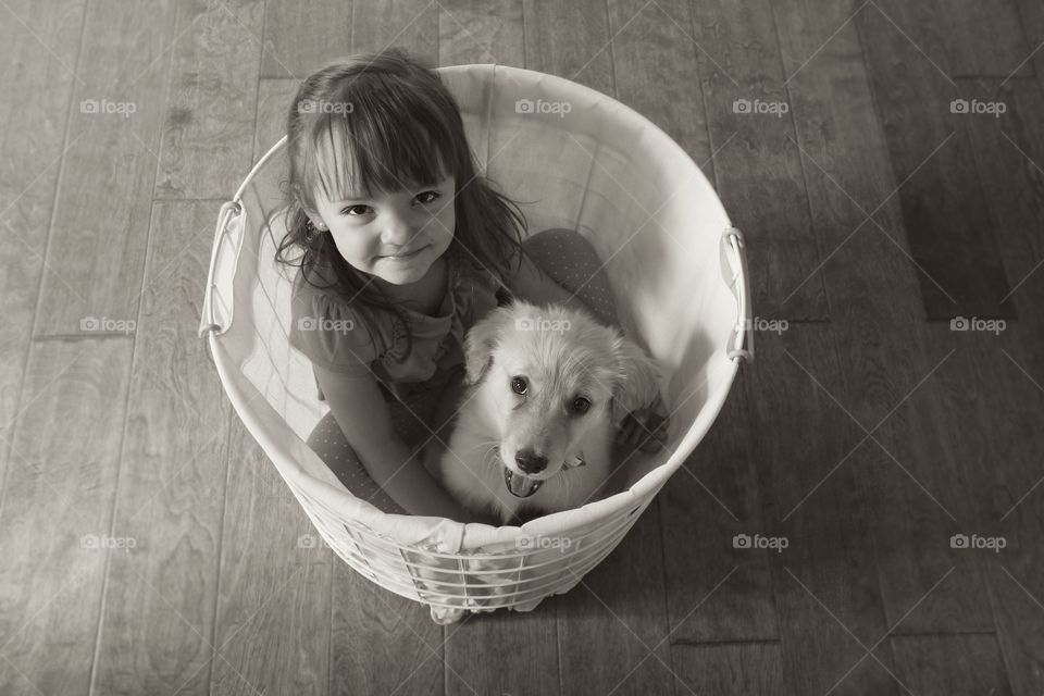 Girl and dog sitting in bucket