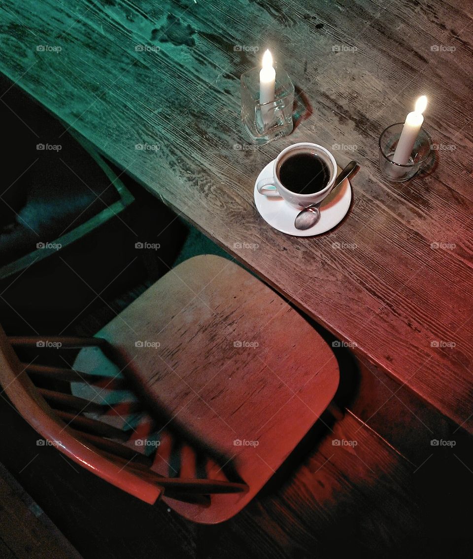 Coffee cup and candles on the brown table