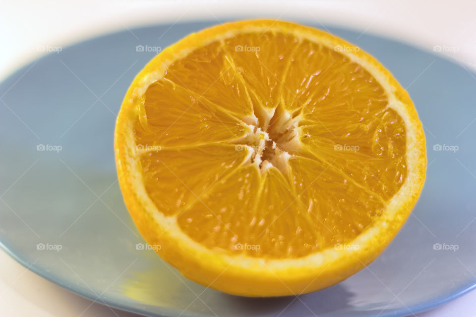 Half orange on blue plate