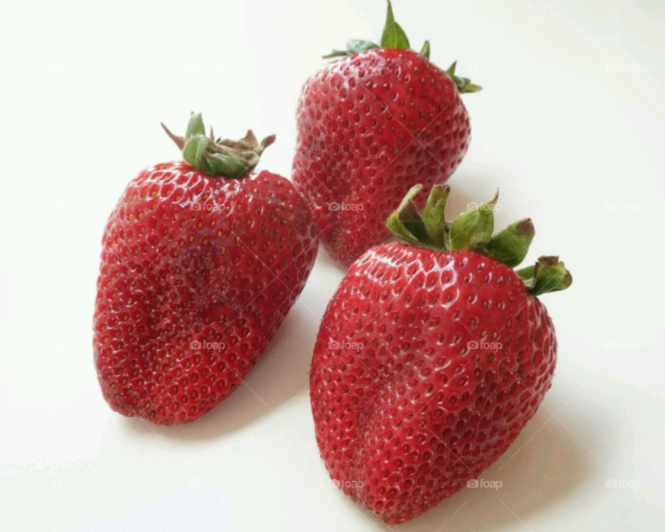 Strawberries against white background