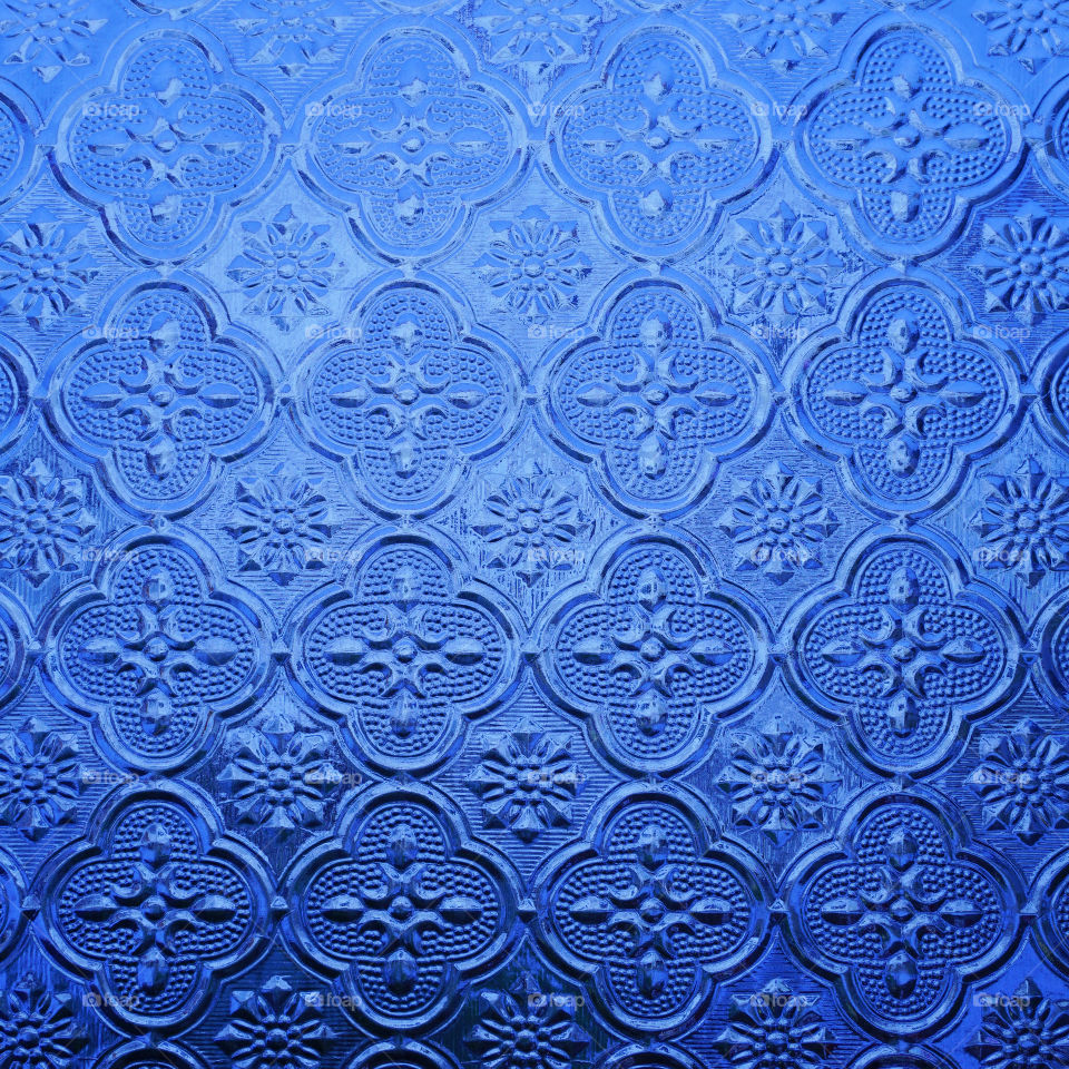 Blue color glass with thai style pattern