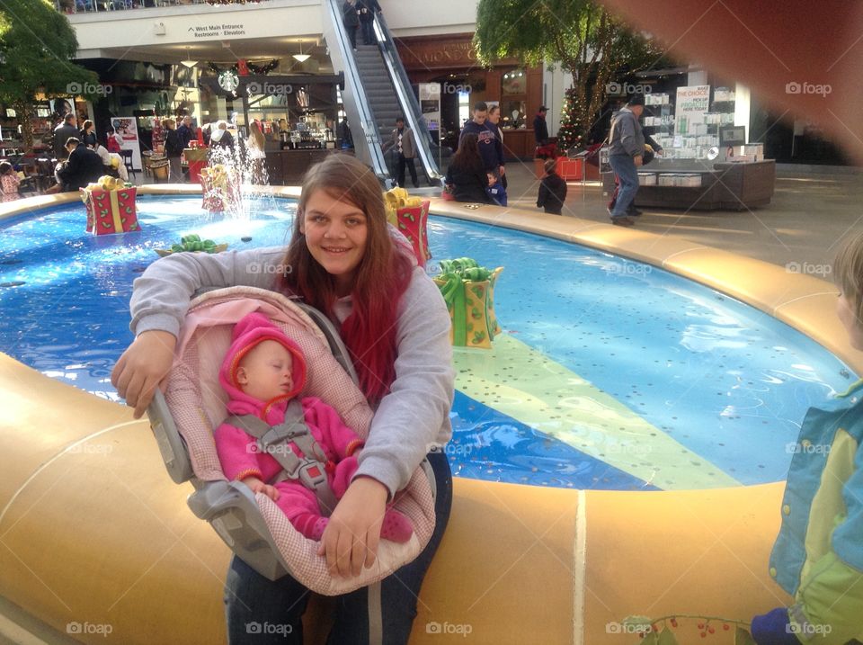 Baby sister with Down syndrome at the mall with her older sister