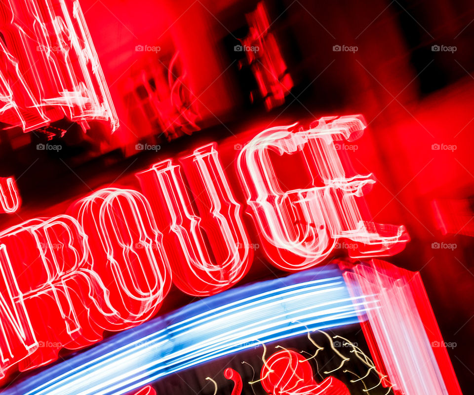 The word rouge spelt out in neon lighting with lens racking making the lights pop out