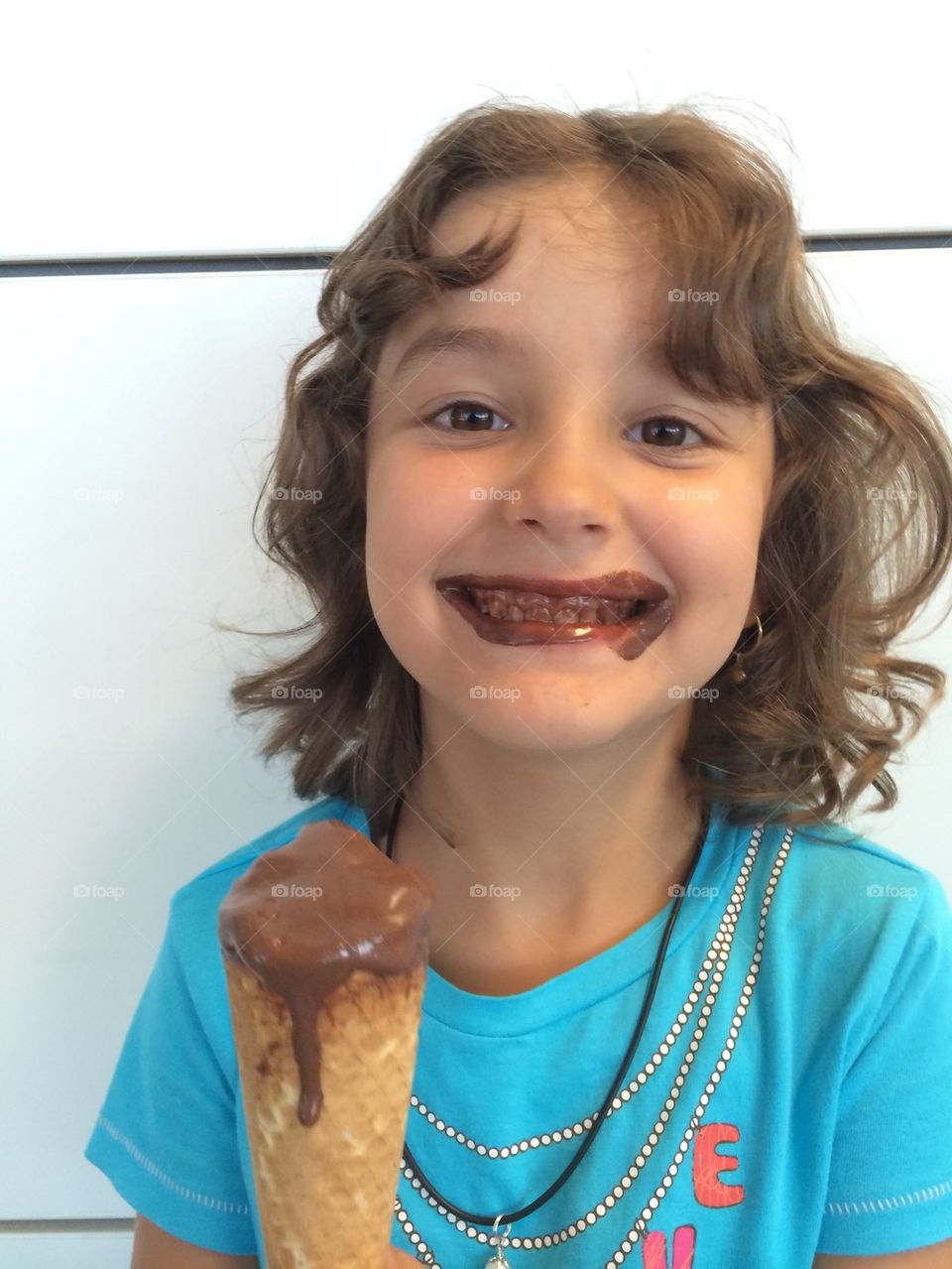 Baby girl with chocolate ice cream