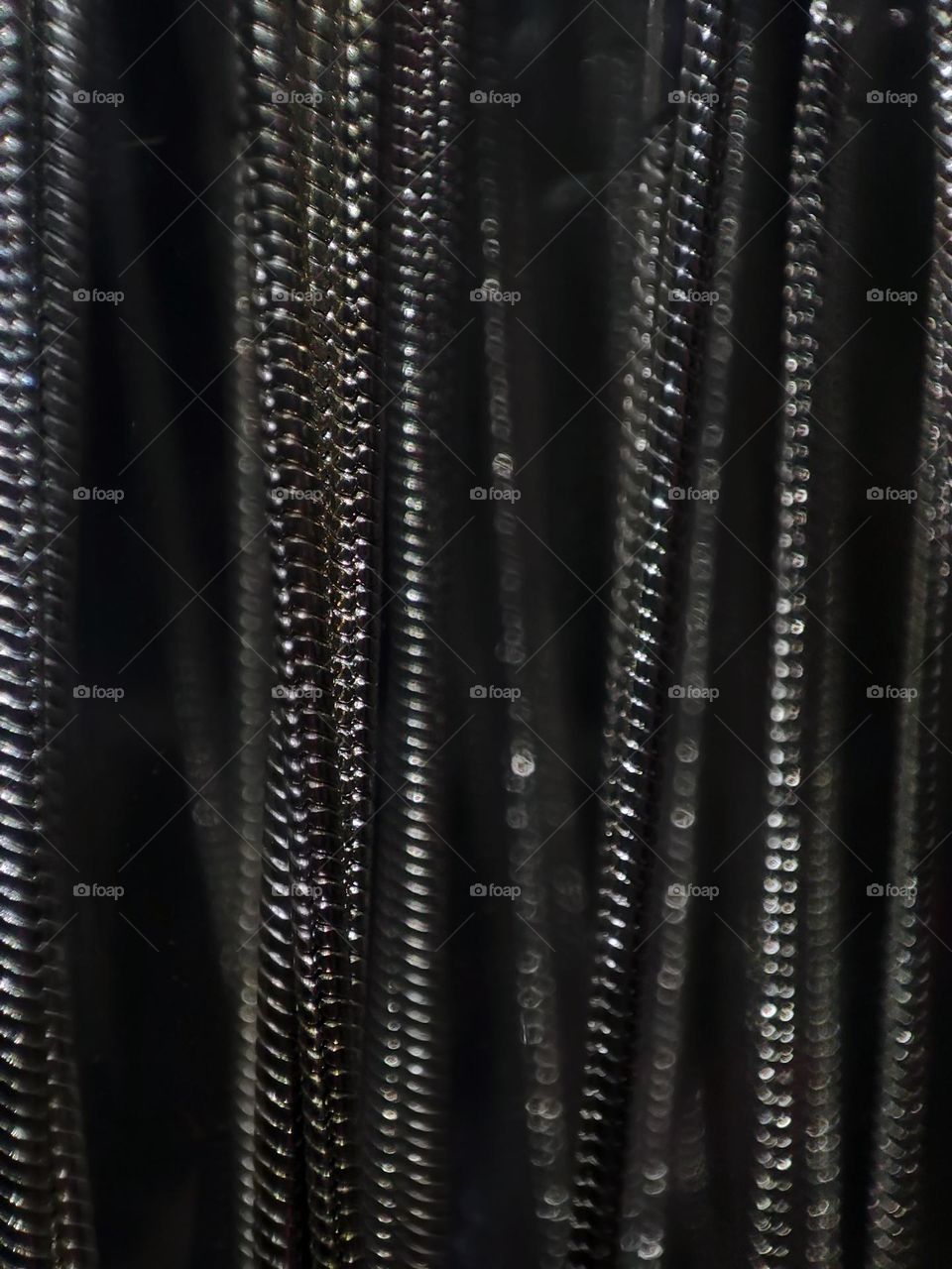 Macro photo of an iron chain hanging on a shelf