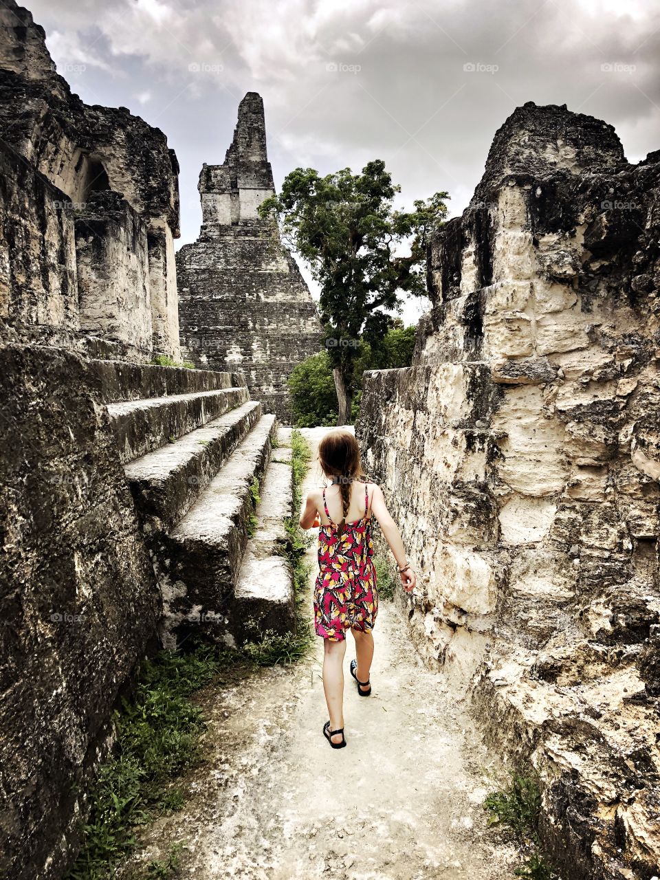 Child walking through Mayan ruins