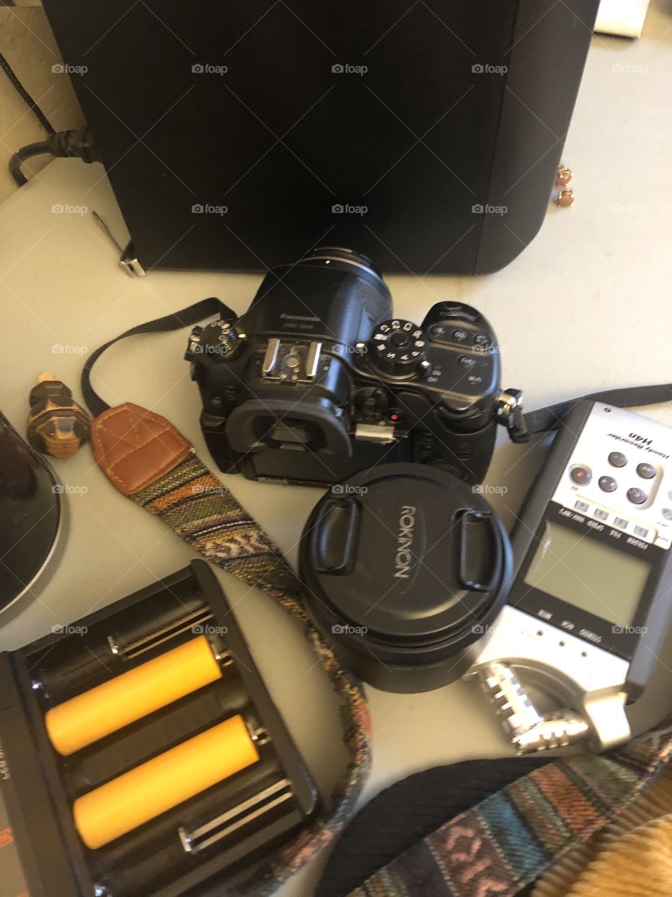 Go to Panasonic camera for  big and small jobs on desk with colorful strap. 