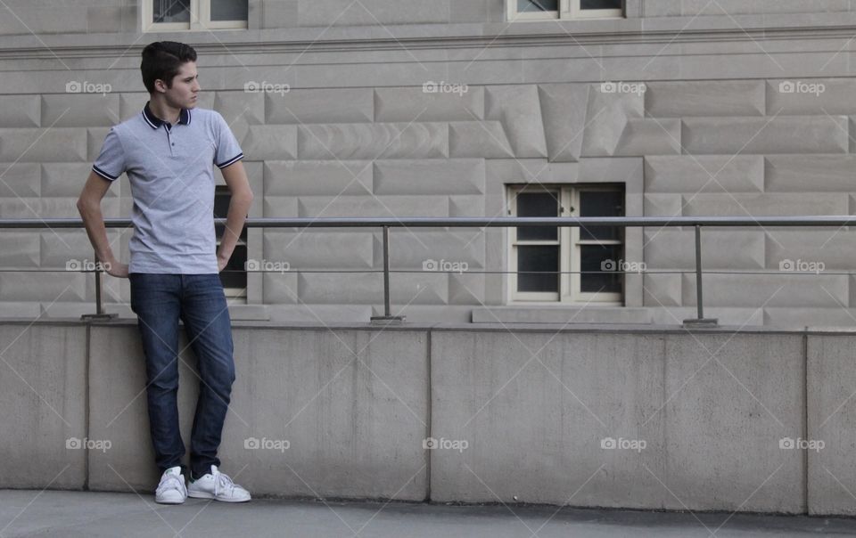Man standing beside building