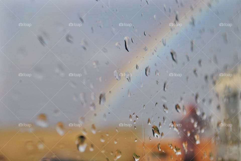 View of raindrops and rainbow