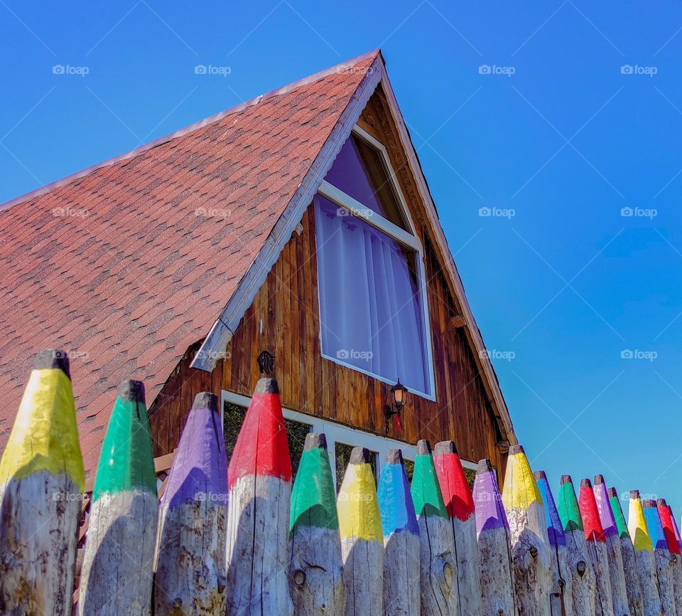 Alpine villa with a wooden painted fence in front