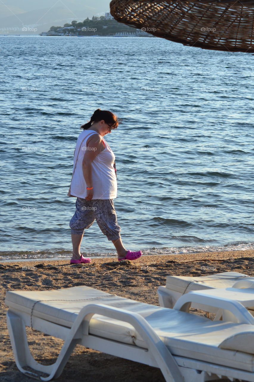 Mature woman walking at beach