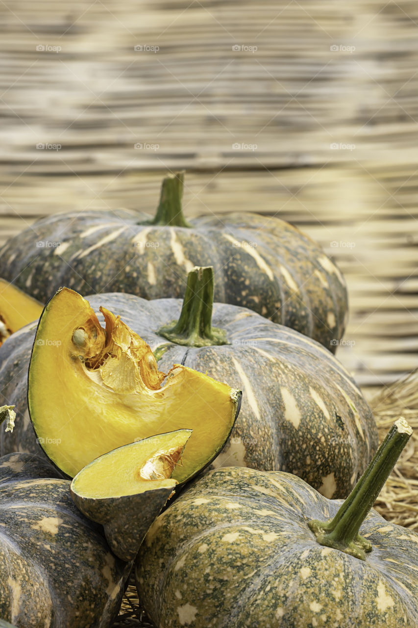 Pumpkin is cut into pieces on the straw.