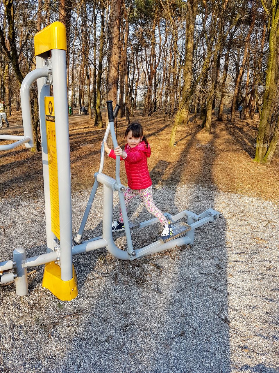 
Little girl exercising outside 