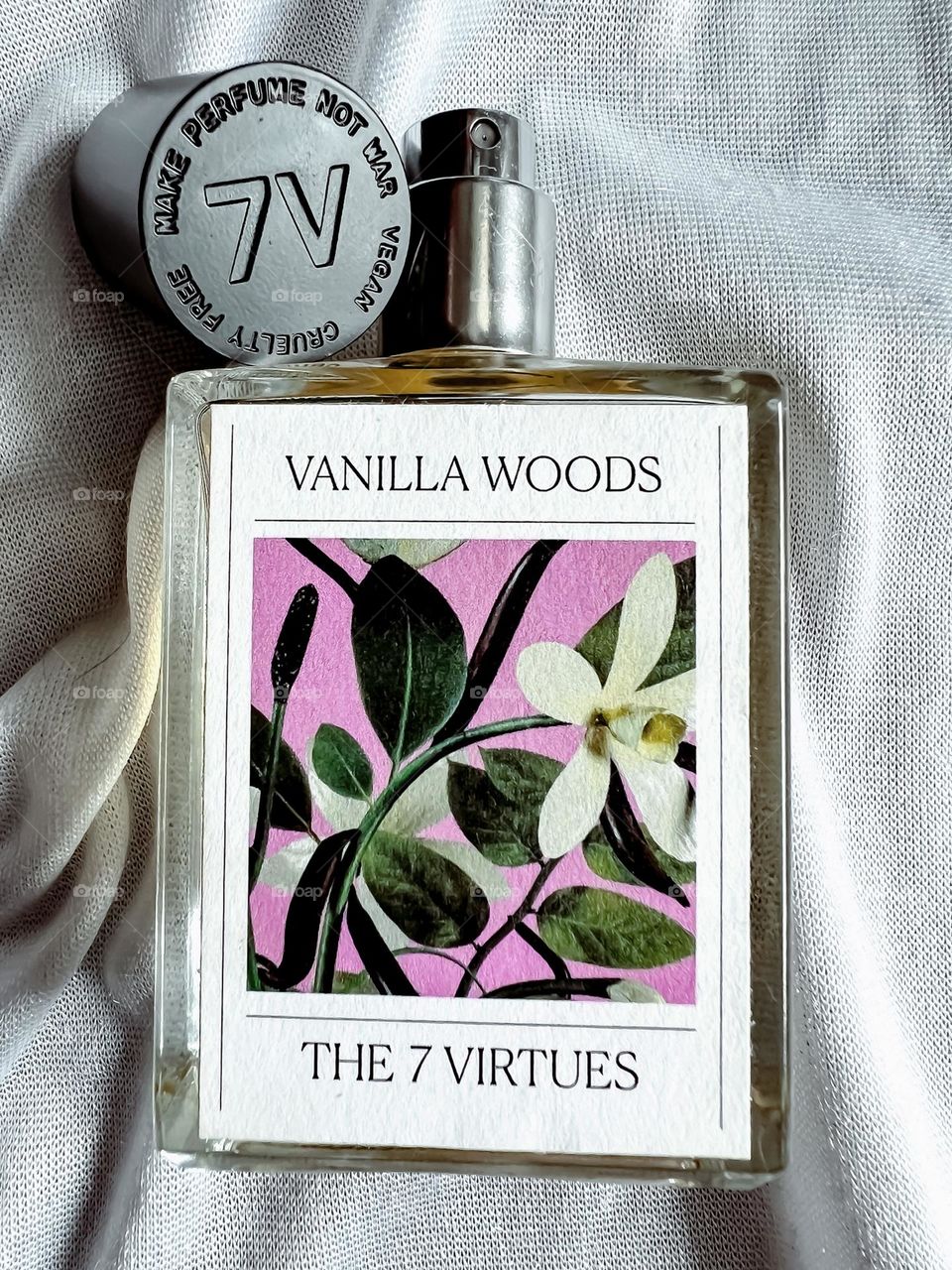 The 7 Virtues Vanilla Woods Perfume bottle close up with the lid off 