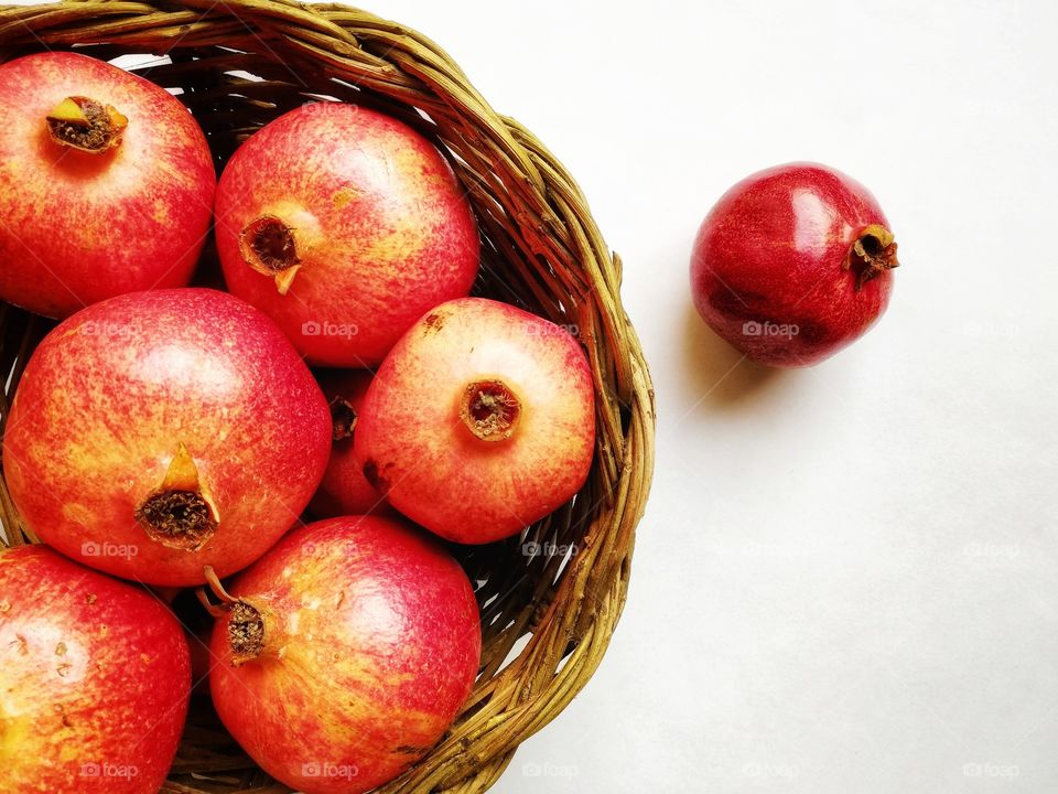 detail of wicker basket with pomegranates