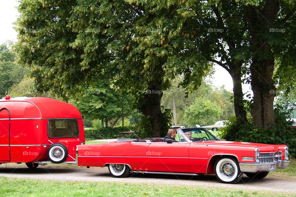 red classic car with caravan