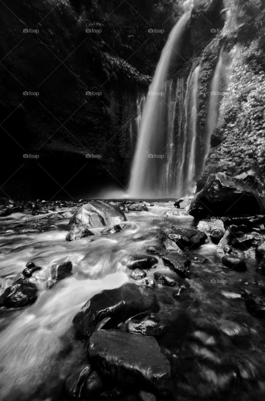 Amazing fine art black and white Tiu Kelep Waterfall near Rinjani, Senaru Lombok indonesia. Southeast Asia. Motion blur and soft focus due to Long Exposure Shot.