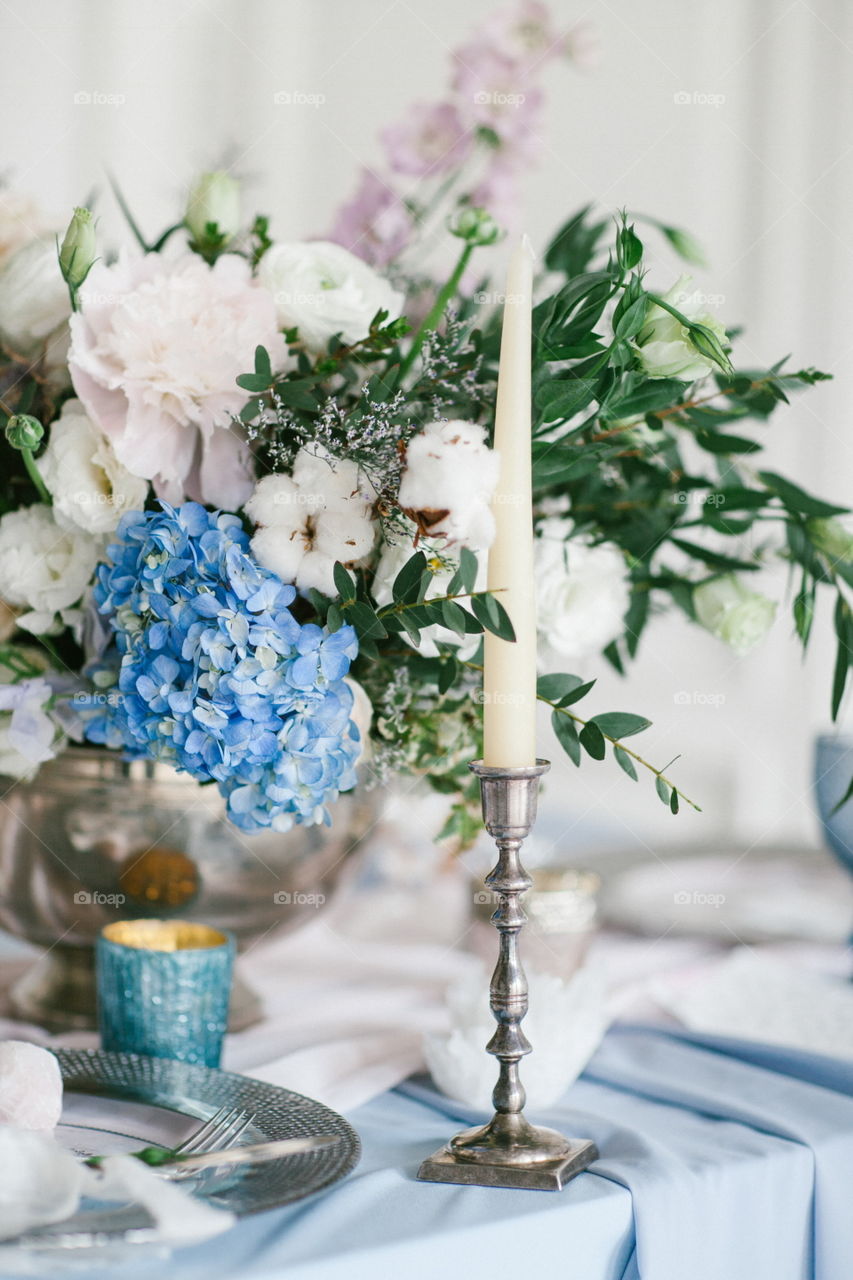 Silver candlestick as element of festive table wedding centerpieces decorations.