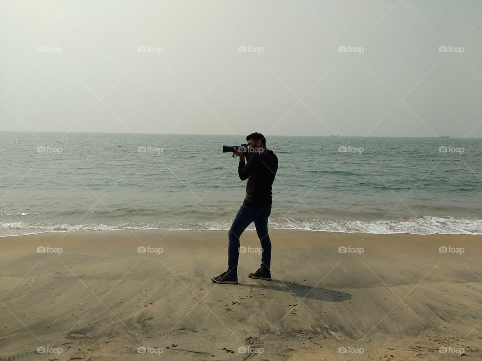 Male photographer at beach