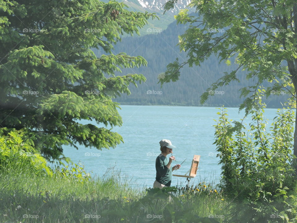 Artist At Work. An artist was painting along a public walkway