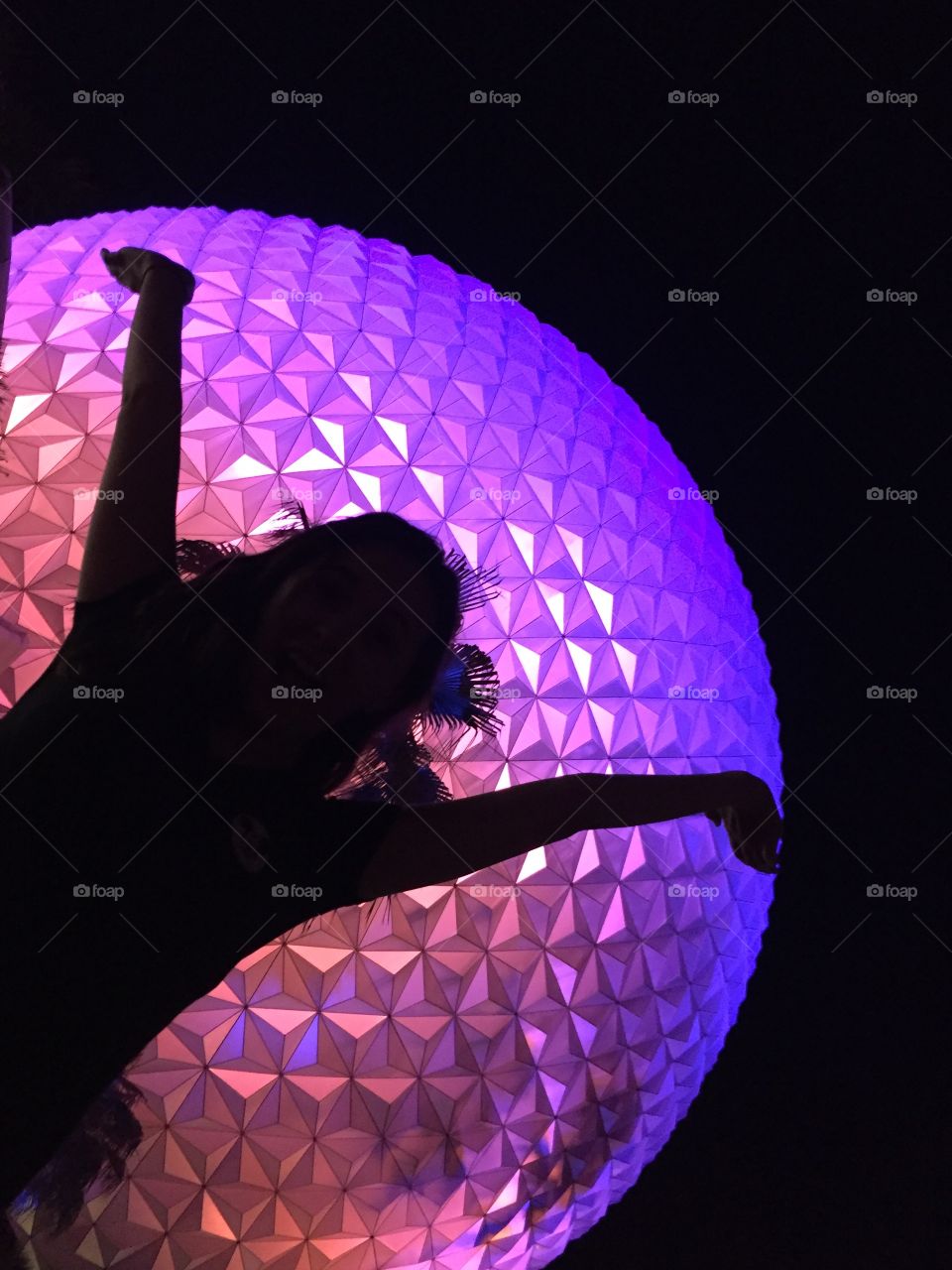 Black silhouette in front of the Epcot Globe in Orlando, FL. 