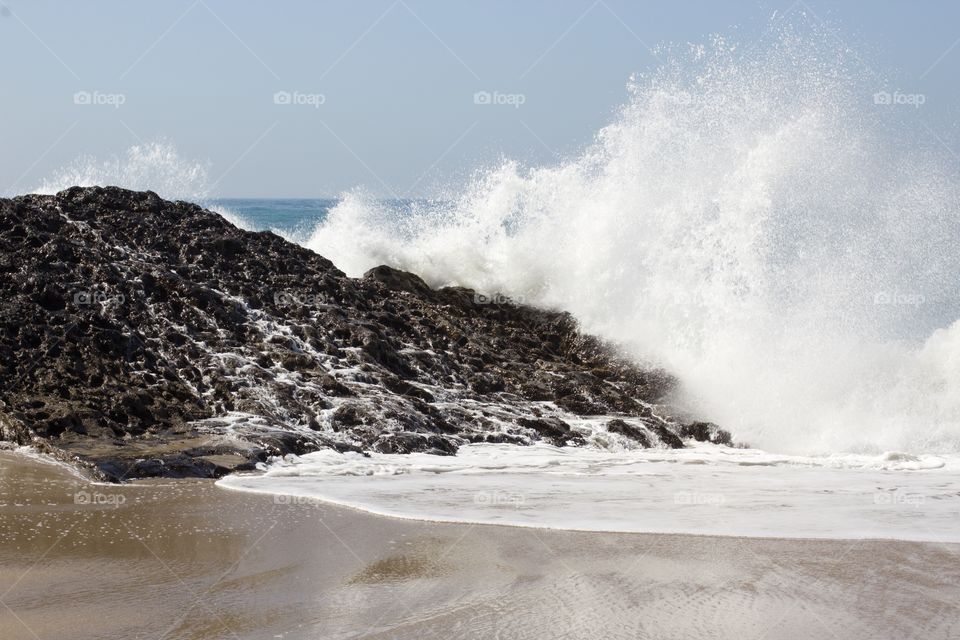 Wave splashing on rock. 