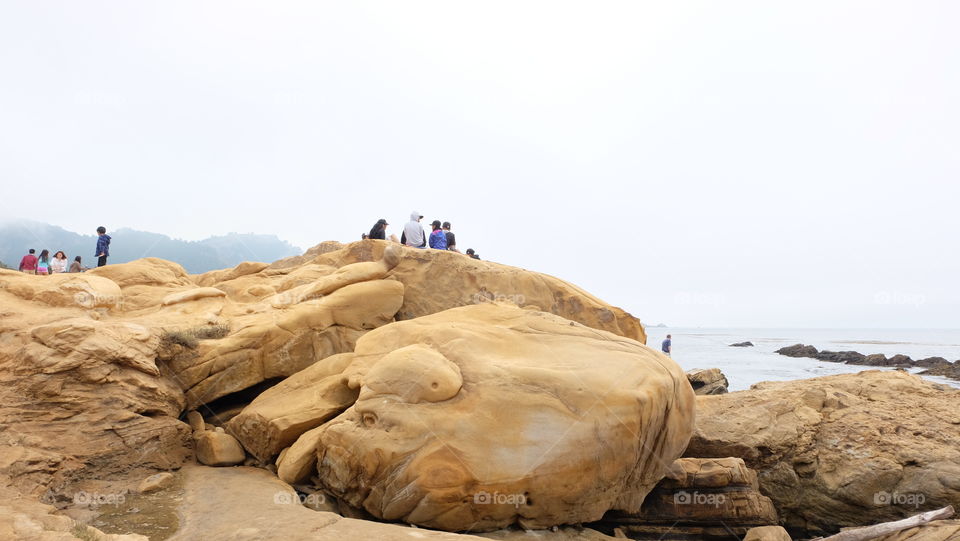 Picnic on yellow coastal rocks