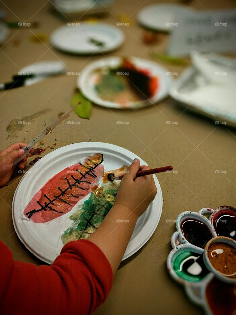 Little hands create colorful leaves for Autumn